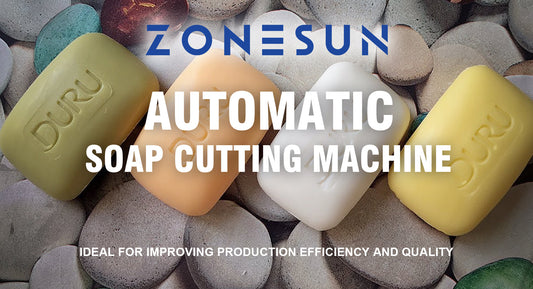 Four bars of soap in green, orange, white, and yellow on smooth stones with Zonesun automatic soap cutting machine text